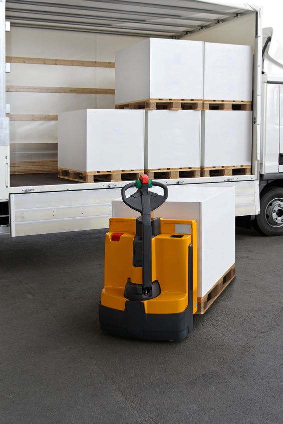  forklift truck loading pallets of paper in truck